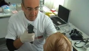 A doctor examining the eyes of an elderly lady